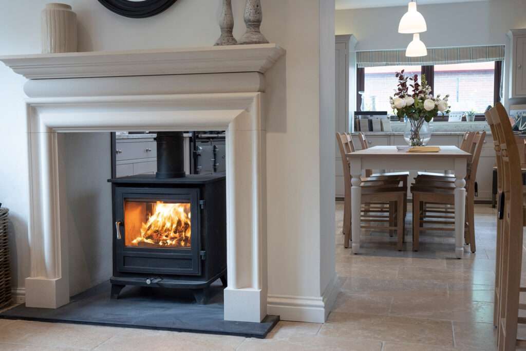 Chesney Salisbury Double Sided 8WS Series installed in a fireplace next to a kitchen.